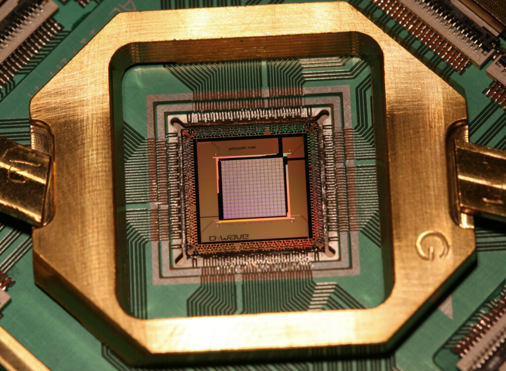 Photograph of the D-Wave TwoX 1000 Qubit quantum annealing processor chip. Source: https://commons.wikimedia.org/wiki/File:D-Wave-Washington-1000Q.jpg